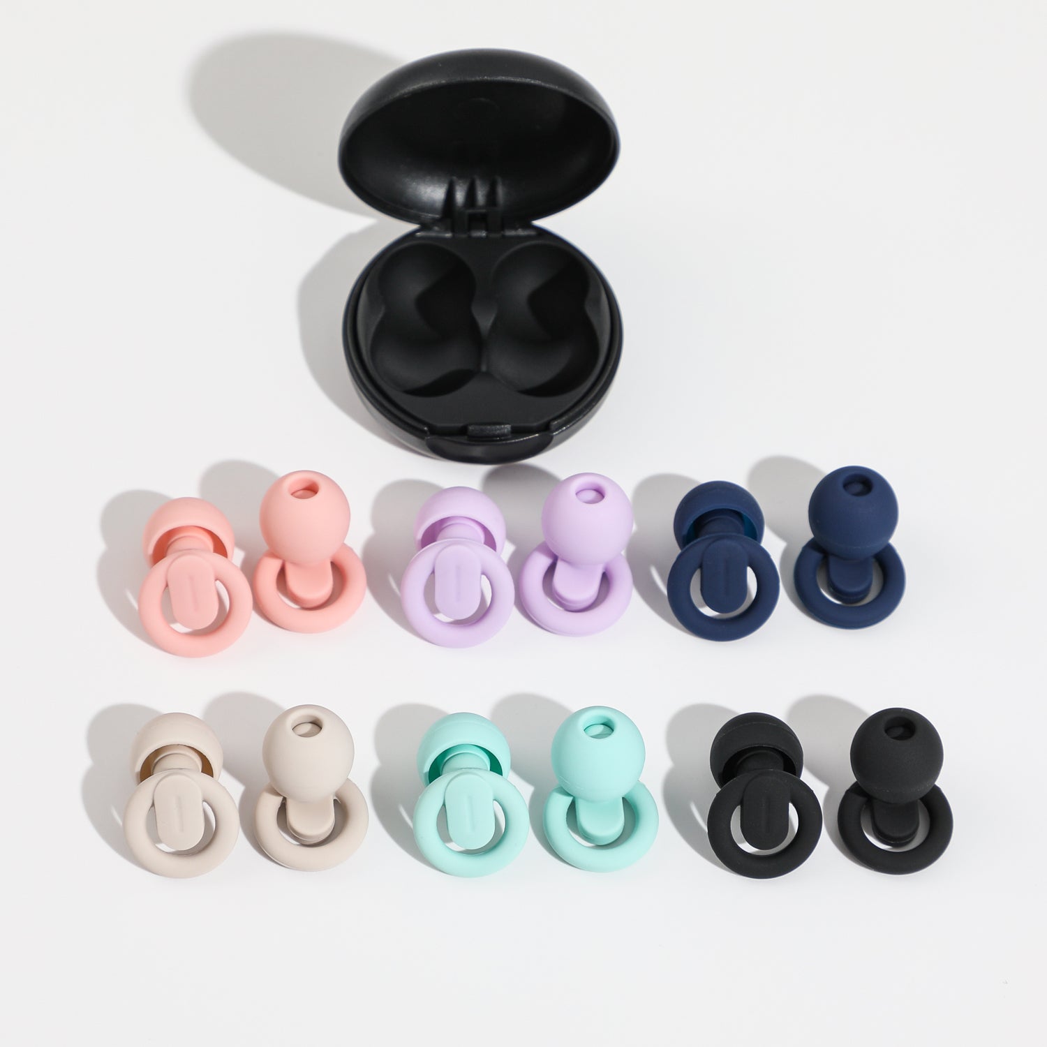 Set of colorful silicone earplugs with a black case on a white background